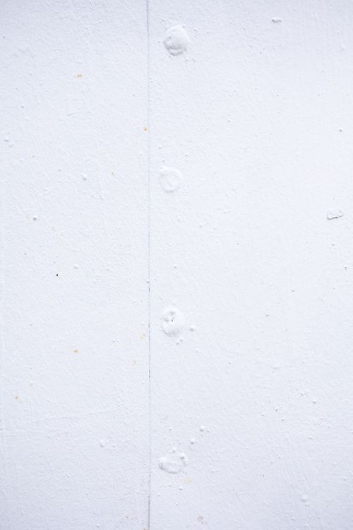 Free Blank background of white shabby wall with stains and irregular dots on surface Stock Photo