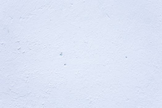 A textured white wall perfect for use as a minimal and clean background.