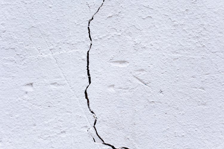 Surface Of Aged White Wall With Crack