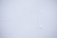 Textured backdrop of wall with spots and dots on shabby light blue surface