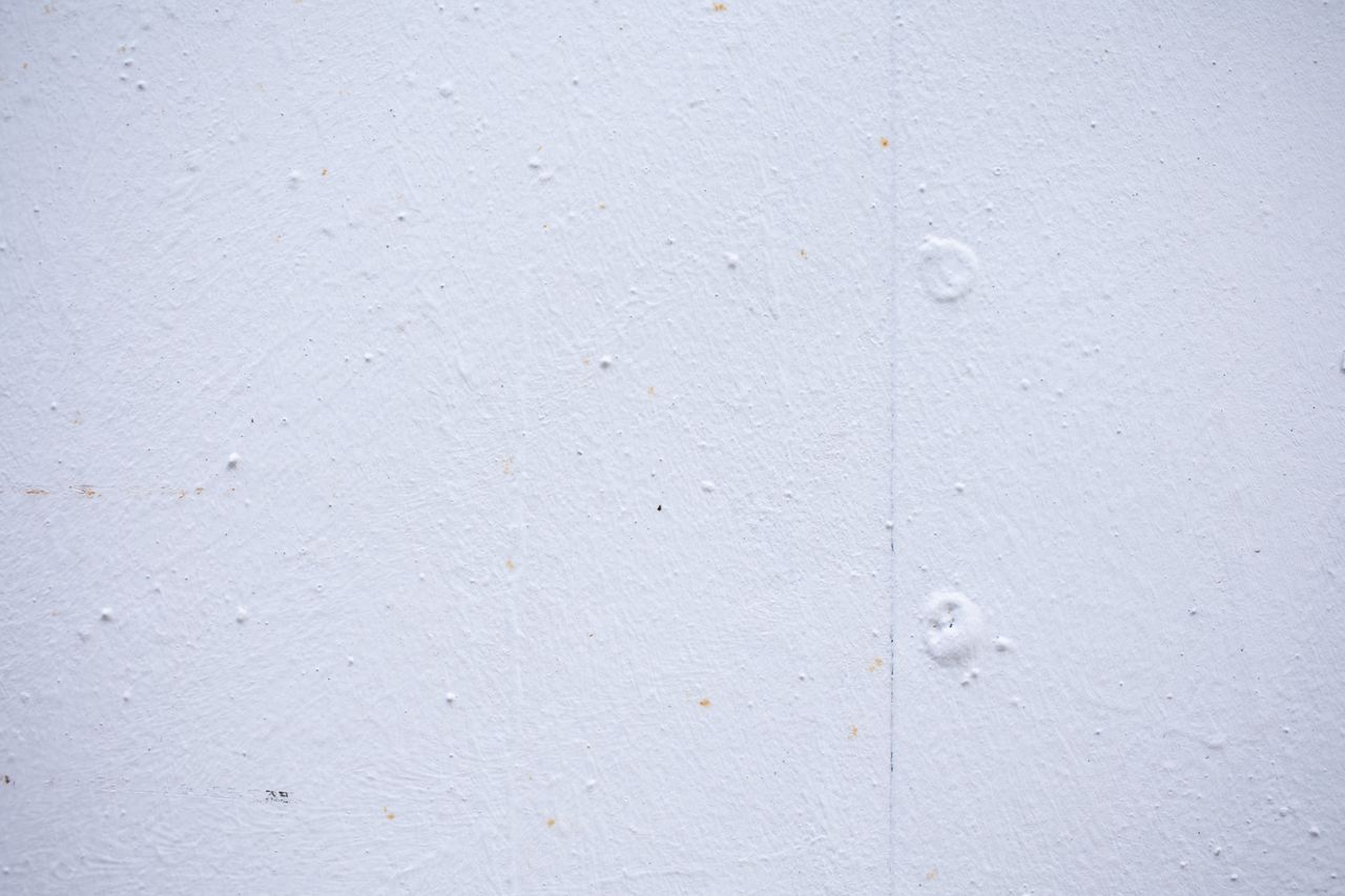 textured backdrop of wall with spots and dots on shabby light blue sur