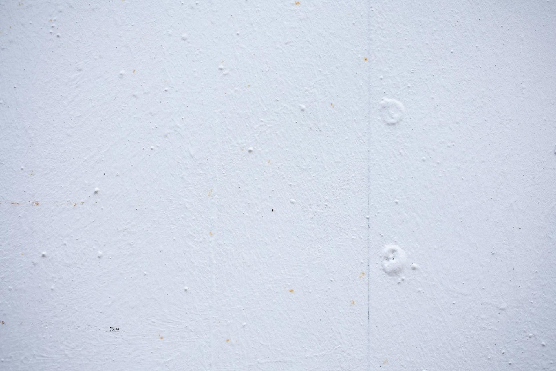 Textured backdrop of wall with spots and dots on shabby light blue surface