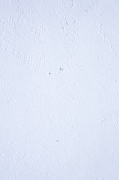 Image of a textured white wall with subtle imperfections, ideal for backgrounds.