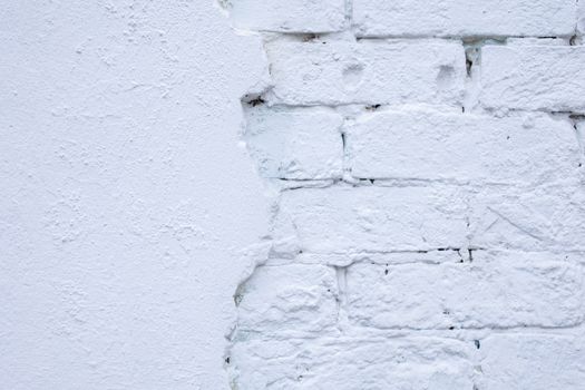 Rough white wall of bricks and plaster