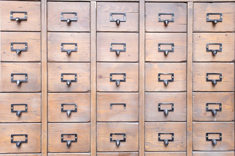 Many Identical Wooden Boxes With Round Handles