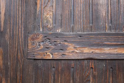 Mur en bois vieilli avec trous et rayures causés par des insectes — traitement vrillettes à Saint-Priest