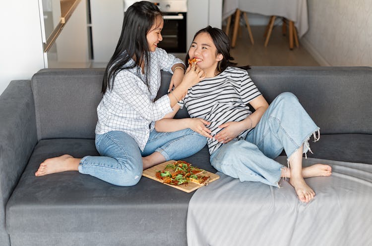 A Pregnant Woman Eating A Pizza