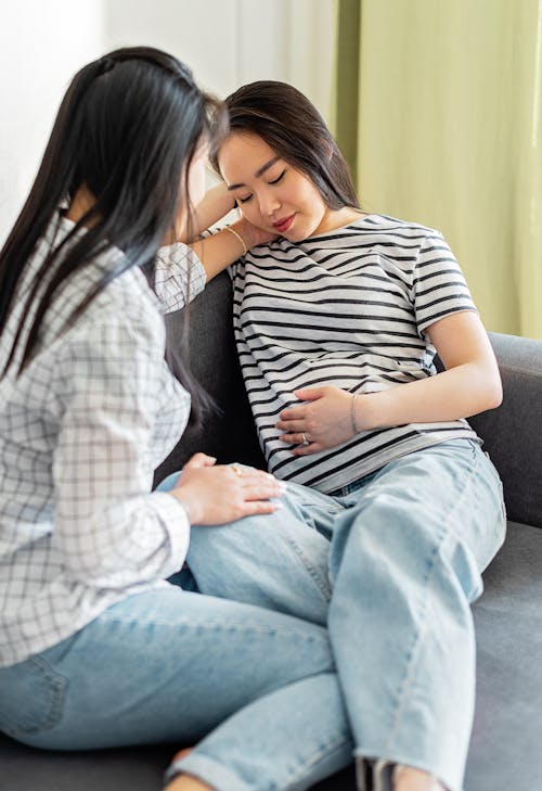 Free Women Sitting on Sofa Stock Photo