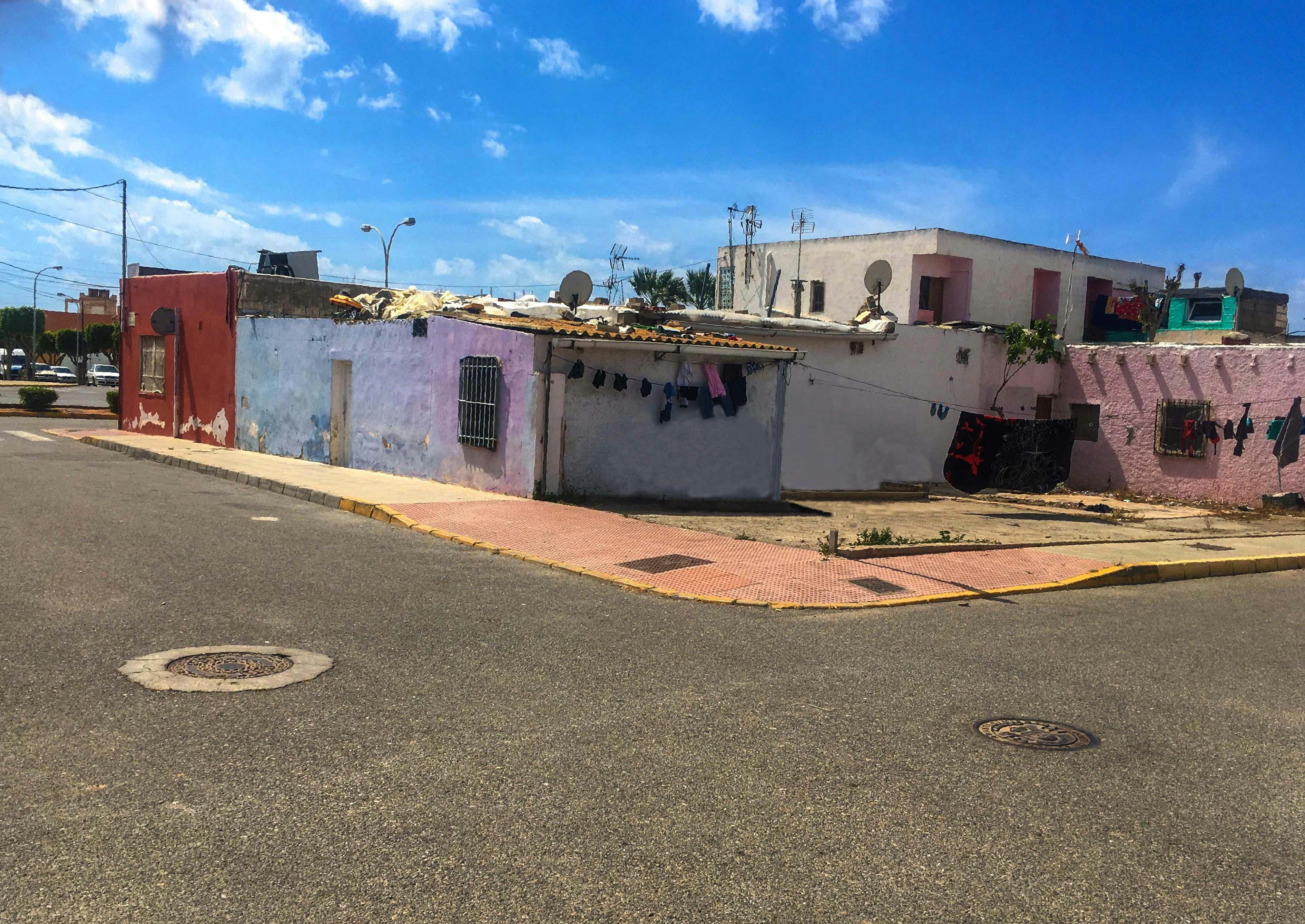 Free Charming rustic street view with colorful houses in San Agustín, Spain under a bright blue sky. Stock Photo