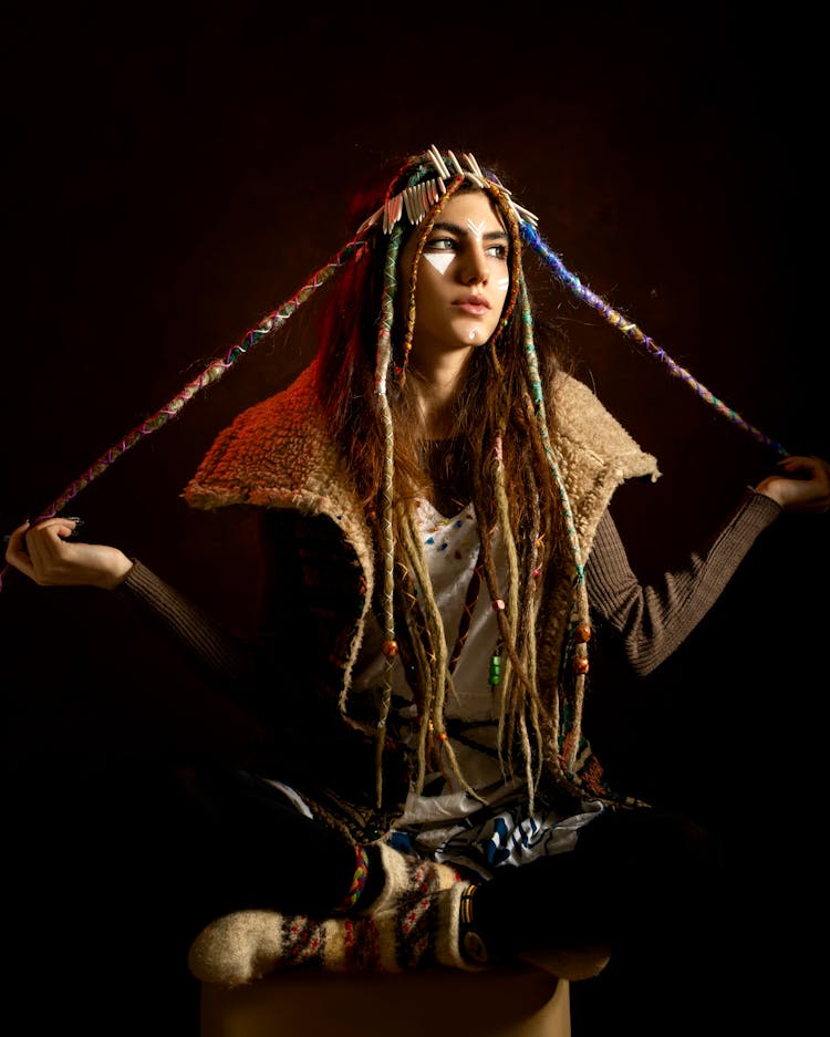 Ethnic Model With Threads On Dreadlocks On Black Background