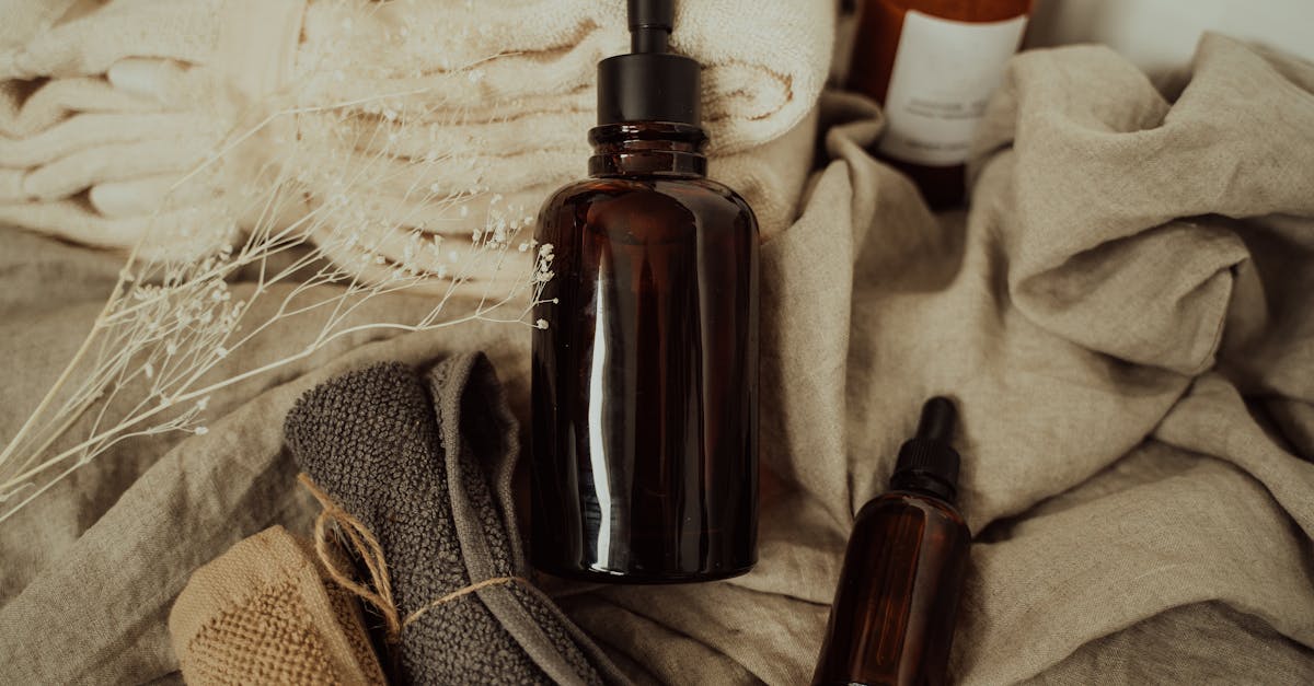 Stylish bathroom setup featuring amber bottles and soft towels for a spa-like experience. Stylish bathroom setup featuring amber bottles and soft towels for a spa-like experience.