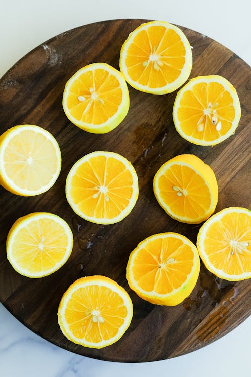 Free Sliced Lemons on a Brown Wooden Board Stock Photo