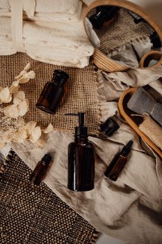 A stylish arrangement of bath products with a rustic touch, featuring towels, bottles, and natural elements.