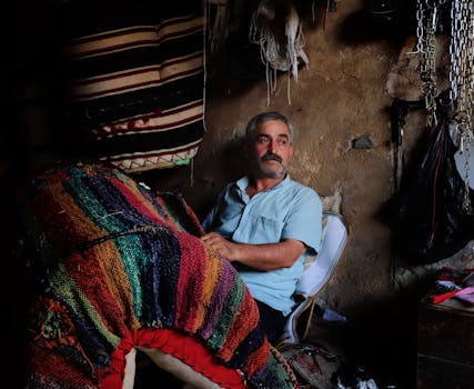 Elderly man engaged in traditional embroidery in Mardin, Türkiye, capturing cultural craftsmanship.