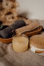Body Scrub in Plastic Jar Beside Body Brush