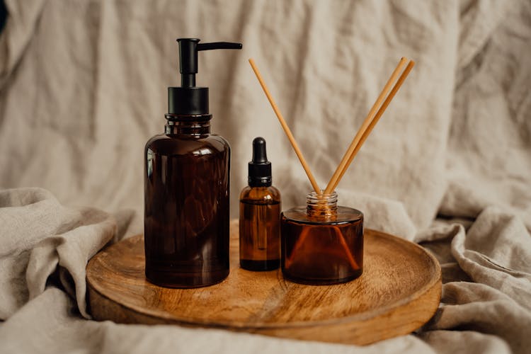 B
Amber Glass Bottles On Wooden Tray 