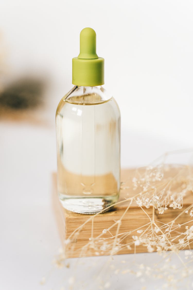 Liquid In A Clear Glass Bottle With Green Dropper