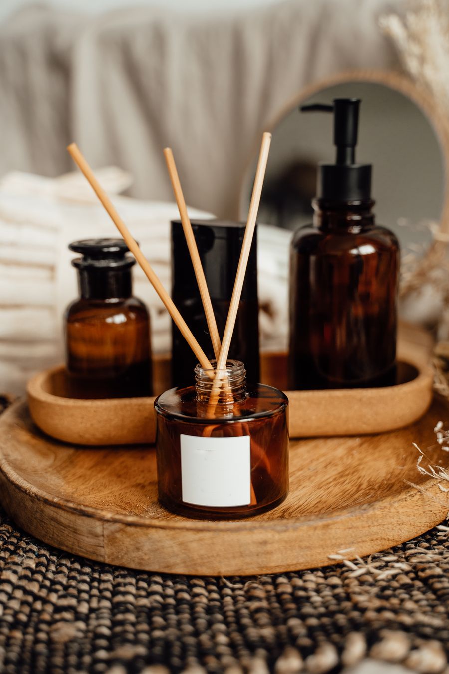 Amber diffuser bottles on a wooden tray