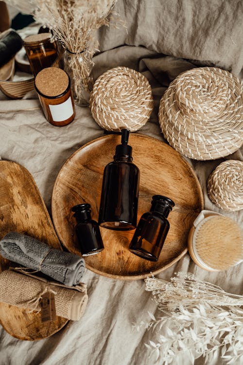 Assorted Brown Bottles on Round Wooden Tray