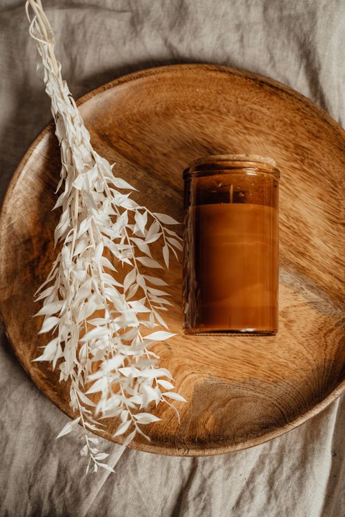 Free Aromatic rustic candle and dried foliage on a wooden tray, creating a serene aesthetic. Stock Photo