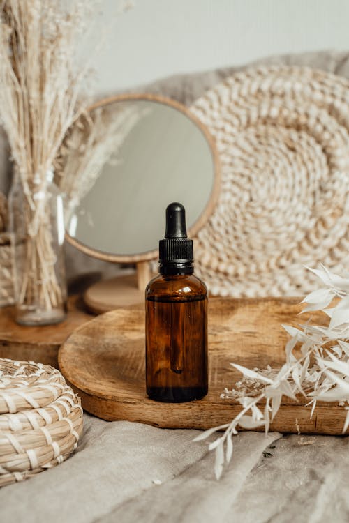 Cosmetic Brown Glass Bottle on Wooden Tray