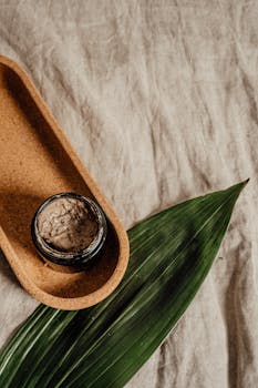 Minimalist flat lay of a skincare jar with natural textures, perfect for eco-friendly beauty brands.
