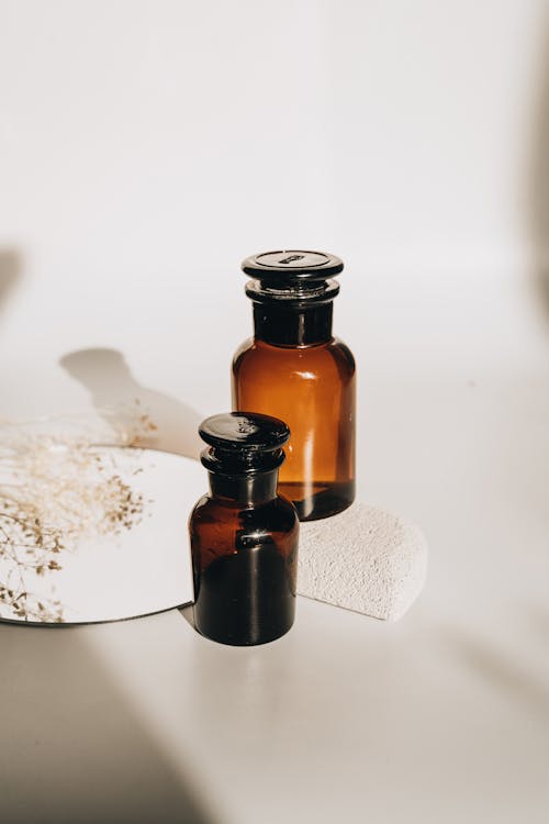 Brown Glass Bottles on White Surface