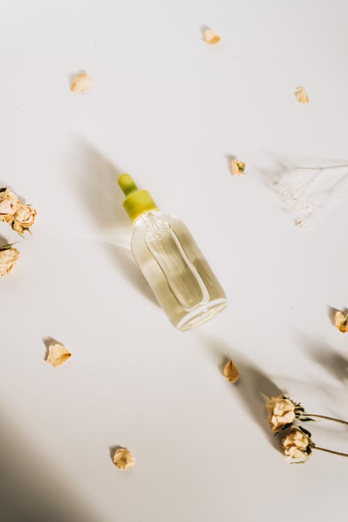Free Bottle with Dropper on White Surface Stock Photo