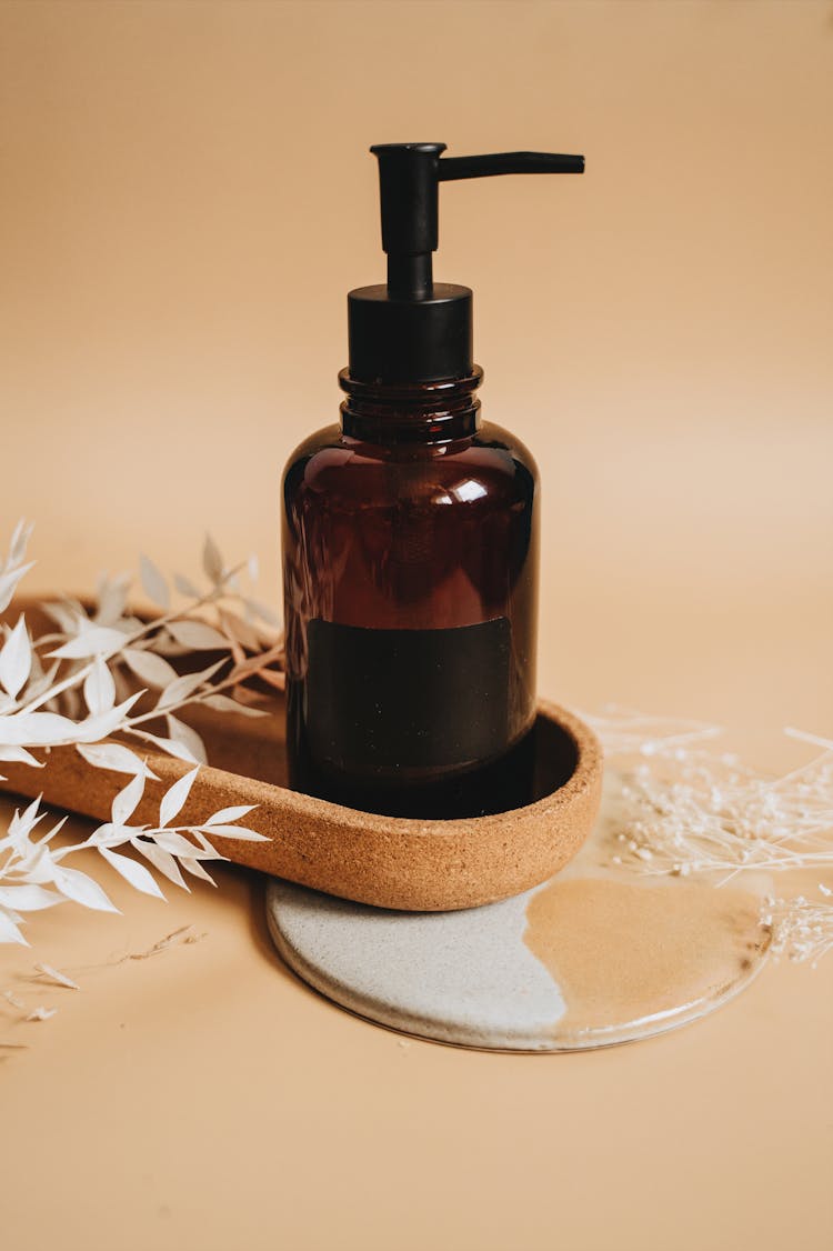 Brown Glass Pump Bottle On Brown Tray