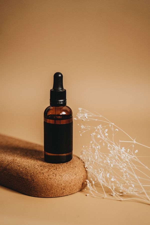 Amber glass bottle with dropper on cork — photo by Alesia Kozik on Pexels