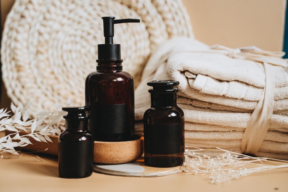Elegant display of toiletry products featuring pump bottles, towels, and natural accents. - High Quality Performance Evaluation