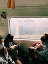 People Wearing Face Masks Inside the Train