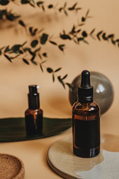 Elegantly styled beauty product shoot featuring essential oil bottles with a natural aesthetic.