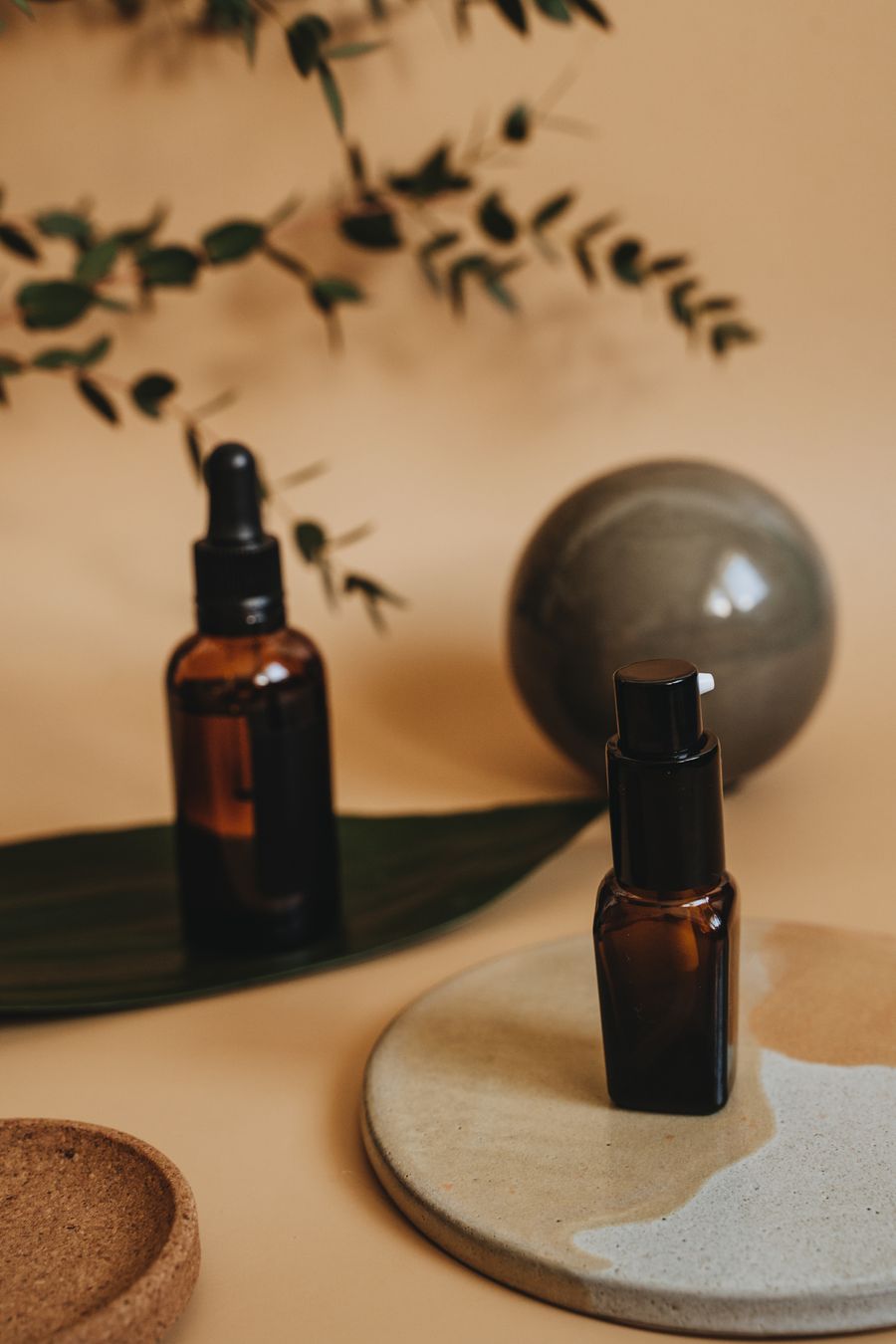 Unbranded cosmetic containers arranged with natural botanical elements