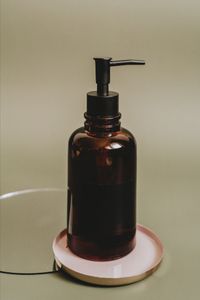Amber pump bottle on a ceramic tray — photo by Alesia Kozik on Pexels