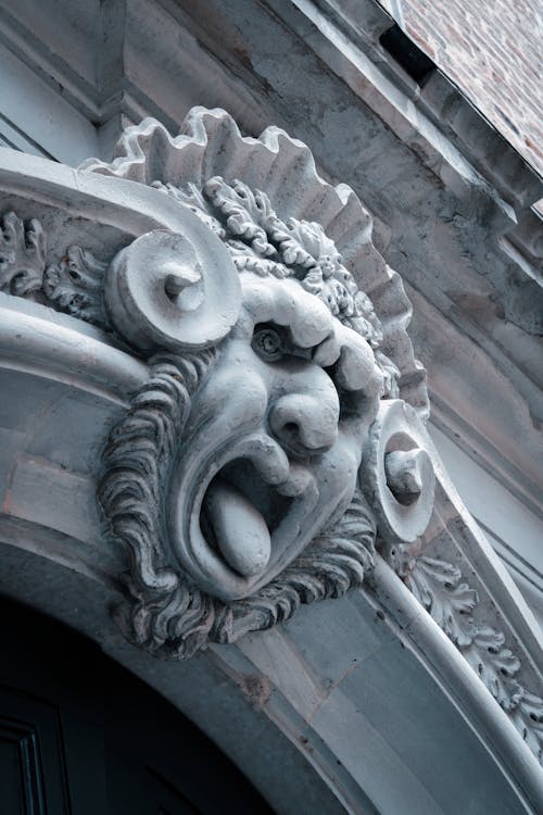 Close Up of Carved Scary Face on Building Facade