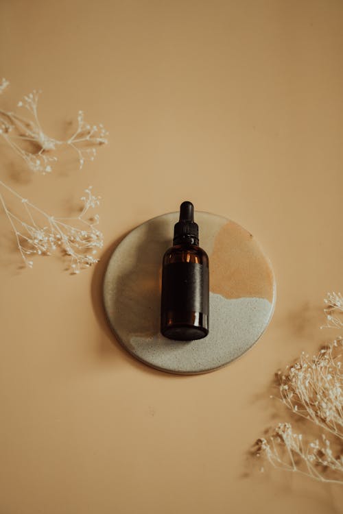 Flatlay Photo of a Brown Bottle with Dropper