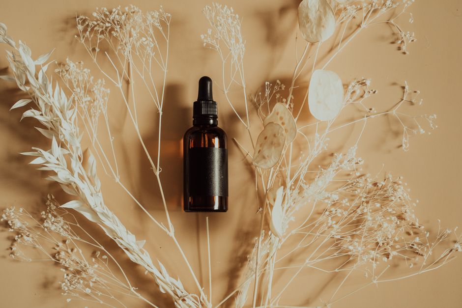 Flat lay of a dropper bottle for a serum. Photo by Alesia Kozik on Pexels