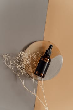 Elegant dropper bottle styled with neutral tones and a minimalistic composition for beauty product presentation.