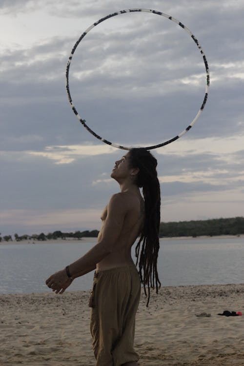 
A Man Balancing a Hula Hoop on His Head
