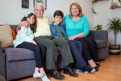 Free Family Sitting on Sofa at Home Stock Photo