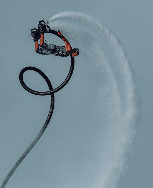 Man Performing Acrobatic Tricks on a Flyboard
