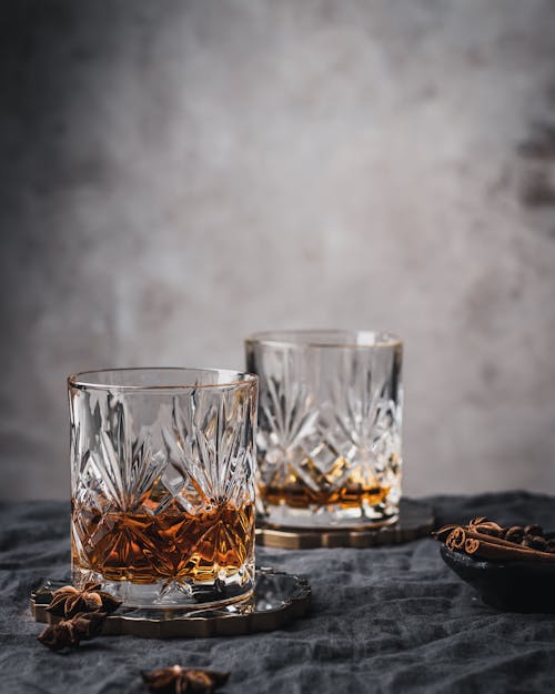 Clear Shot Glass on Black Wooden Table