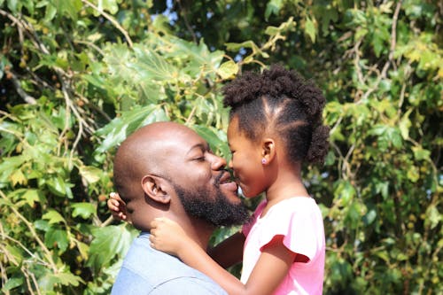 Free A Man Kissing a Young Girl Stock Photo