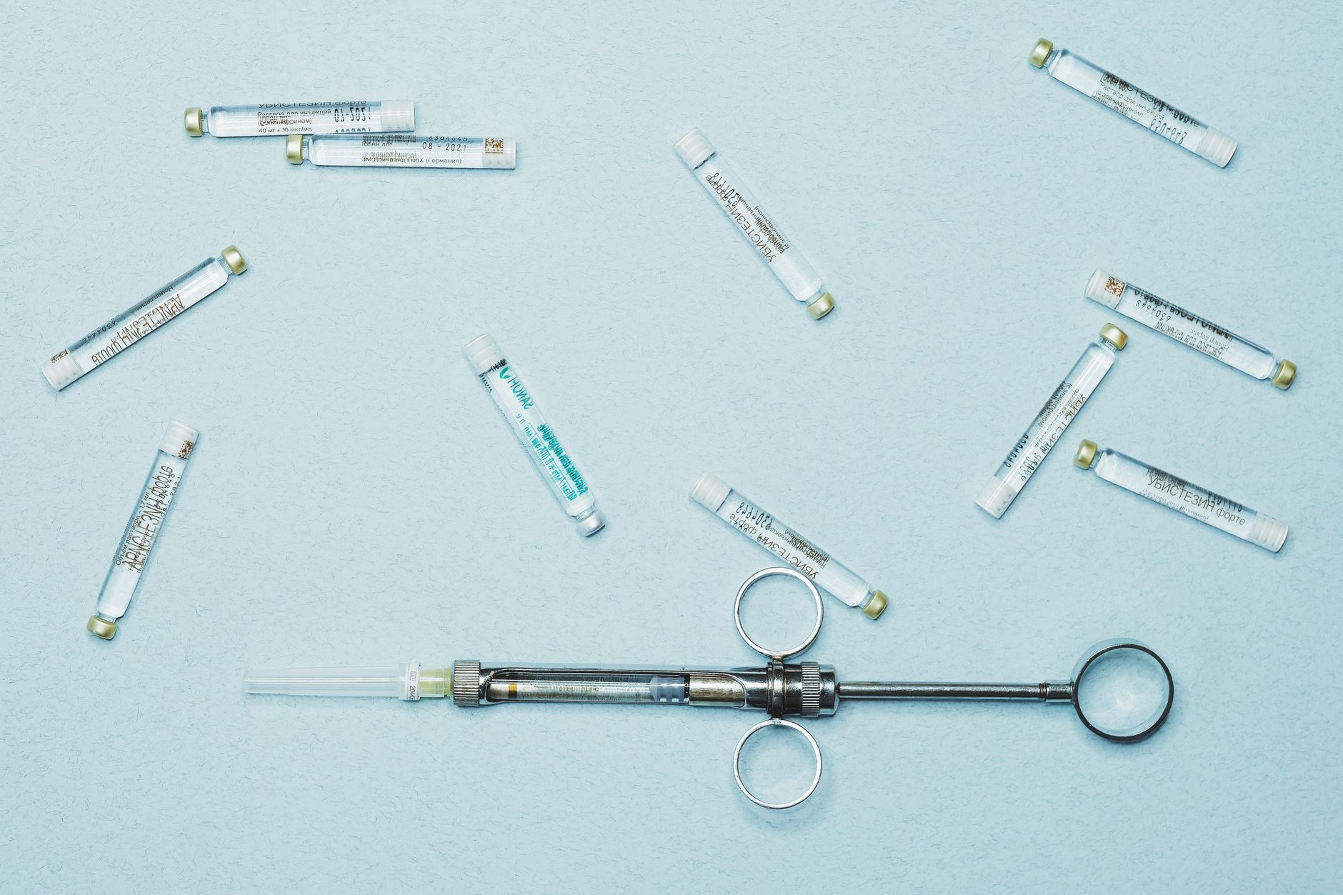 Flat lay of a syringe and vials, ideal for medical themes.