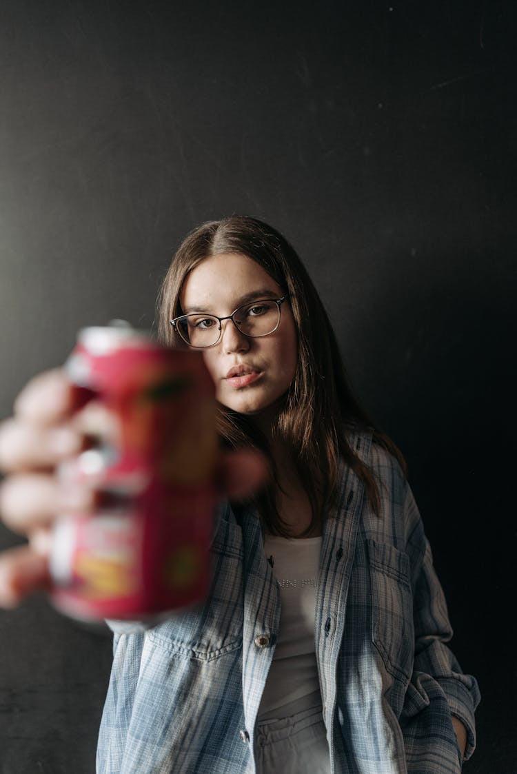 Photo Of A Woman Holding A Can