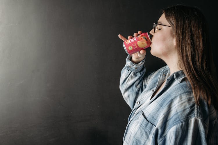 Woman Drinking Soda In Can