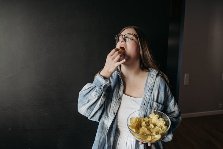 Woman Standing With A Bowl Of Chips