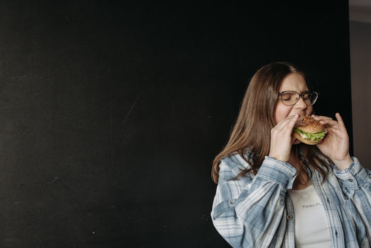 A Woman Eating A Hamburger 