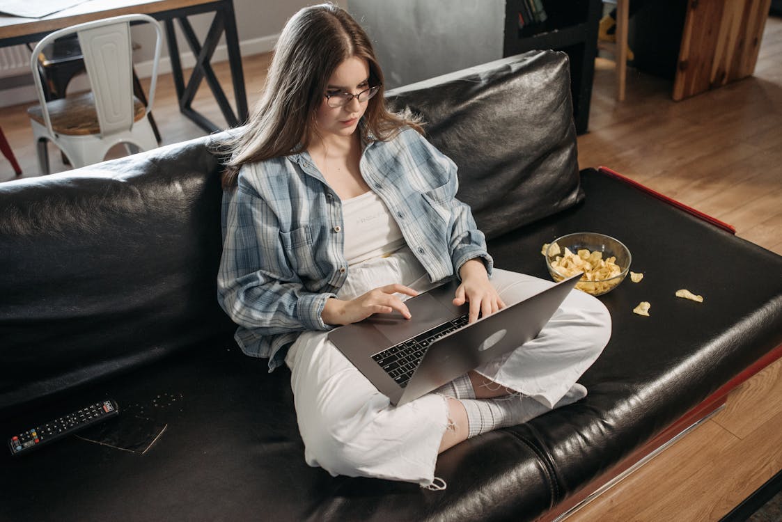 Free Woman Sitting Near a Bowl of Chips Stock Photo